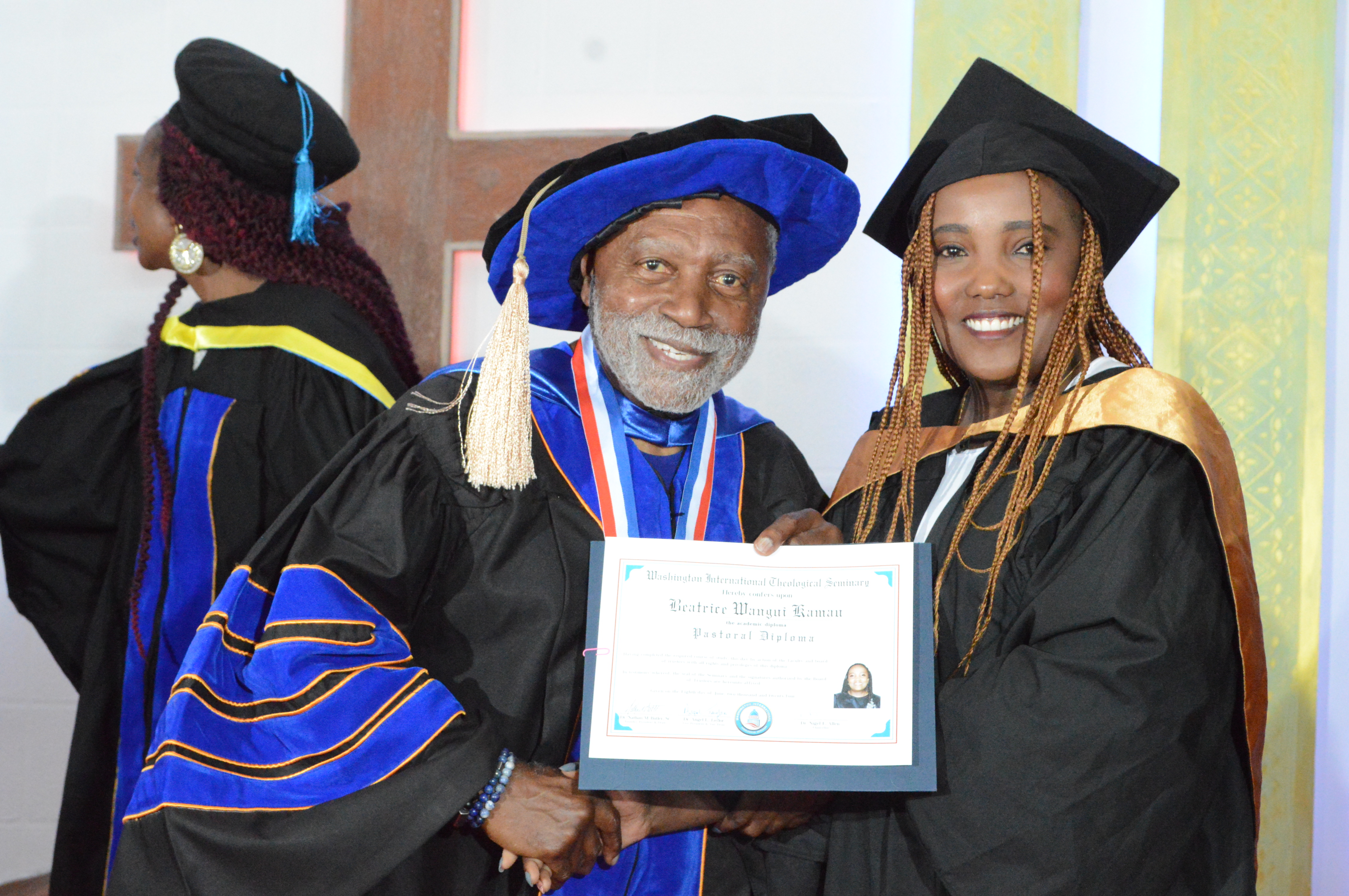 A graduate receiving her diploma during commencement